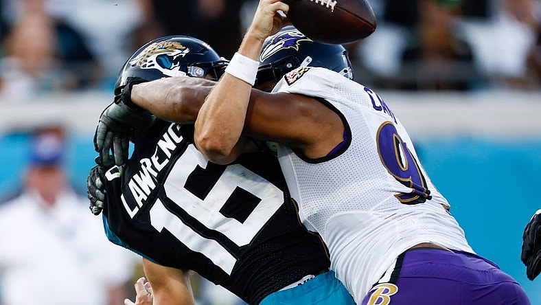 Nov 27, 2022; Jacksonville, Florida, USA; Baltimore Ravens defensive tackle Calais Campbell (93) sacks Jacksonville Jaguars quarterback Trevor Lawrence (16) during the fourth quarter at TIAA Bank Field. Mandatory Credit: Douglas DeFelice-USA TODAY Sports