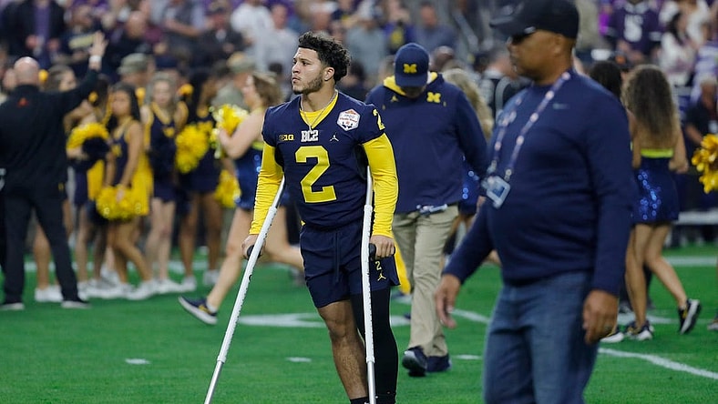Michigan running back Blake Corum (2) is seen on the field on crutches before the start of the Fiesta Bowl against TCU on Saturday, Dec. 31 at State Farm Stadium in Glendale, Ariz.

H3 3755