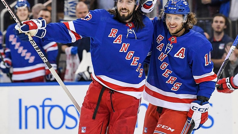 Jan 3, 2023; New York, New York, USA; New York Rangers left wing Artemi Panarin (10) celebrates the goal by New York Rangers center Mika Zibanejad (93) against the Carolina Hurricanes during the second period at Madison Square Garden. Mandatory Credit: Dennis Schneidler-USA TODAY Sports