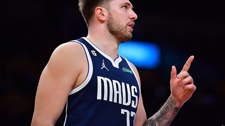 Jan 12, 2023; Los Angeles, California, USA; Dallas Mavericks guard Luka Doncic (77) reacts against the Los Angeles Lakers during the first half at Crypto.com Arena. Mandatory Credit: Gary A. Vasquez-USA TODAY Sports