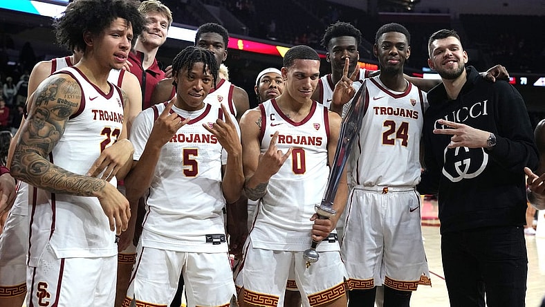January 14, 2023; Los Angeles, California, USA; Southern California Trojans guard Tre White (22), guard Boogie Ellis (5), forward Kobe Johnson (0) and forward Joshua Morgan (24) pose with former player Nick Rakocevic after the game against the Utah Utes in the second half at Galen Center. Mandatory Credit: Kirby Lee-USA TODAY Sports