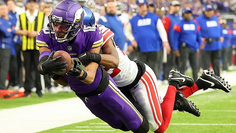 Jan 15, 2023; Minneapolis, Minnesota, USA; Minnesota Vikings wide receiver Justin Jefferson (18) dives for the end zone as New York Giants cornerback Adoree' Jackson (22) defends during the first quarter of a wild card game at U.S. Bank Stadium. The call on the field was a touchdown but was changed after review. Mandatory Credit: Matt Krohn-USA TODAY Sports