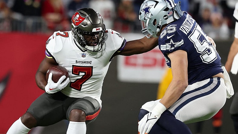 Jan 16, 2023; Tampa, Florida, USA; Tampa Bay Buccaneers running back Leonard Fournette (7) rushes the ball against the Dallas Cowboys linebacker Leighton Vander Esch (55) in the first half during the wild card game at Raymond James Stadium. Mandatory Credit: Kim Klement-USA TODAY Sports