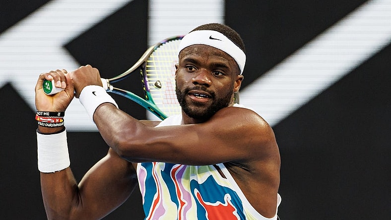 Jan 20, 2023; Melbourne, Victoria, Australia;  Frances Tiafoe of the United States hits a shot against Karen Kachanov of Russia on day five of the 2023 Australian Open tennis tournament at Melbourne Park. Mandatory Credit: Mike Frey-USA TODAY Sports
