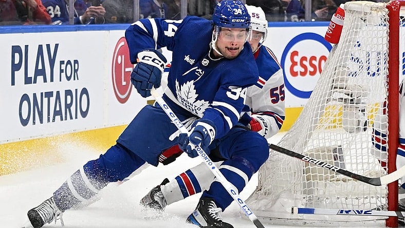 Jan 25, 2023; Toronto, Ontario, CAN;   Toronto Maple Leafs forward Auston Matthews (34) skates with the puck as New York Rangers defenseman Ryan Lindgren (55) defends in the third period at Scotiabank Arena. Mandatory Credit: Dan Hamilton-USA TODAY Sports