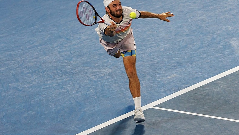 Jan 27, 2023; Melbourne, Victoria, Australia; Tommy Paul of the United States hits a shot against Novak Djokovic of Serbia on day twelve of the 2023 Australian Open tennis tournament at Melbourne Park. Mandatory Credit: Mike Frey-USA TODAY Sports