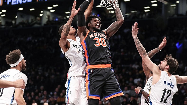 Jan 28, 2023; Brooklyn, New York, USA;  New York Knicks forward Julius Randle (30) drives past Brooklyn Nets center Nic Claxton (33) for a layup attempt in the second quarter at Barclays Center. Mandatory Credit: Wendell Cruz-USA TODAY Sports