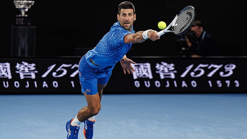 Jan 29, 2023; Melbourne, Victoria, Australia; Novak Djokovic of Serbia hits a shot against Stefanos Tsitsipas of Greece at the men's final on day fourteen of the 2023 Australian Open tennis tournament at Melbourne Park. Mandatory Credit: Mike Frey-USA TODAY Sports