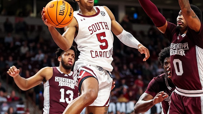 Jan 31, 2023; Columbia, South Carolina, USA; South Carolina Gamecocks guard Meechie Johnson (5) passes around Mississippi State Bulldogs forward D.J. Jeffries (0) in the first half at Colonial Life Arena. Mandatory Credit: Jeff Blake-USA TODAY Sports