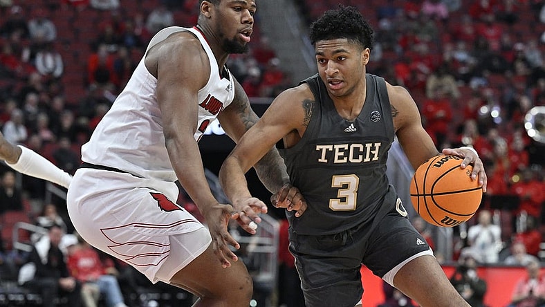 Feb 1, 2023; Louisville, Kentucky, USA;  Georgia Tech Yellow Jackets guard Dallan Coleman (3) dribbles against Louisville Cardinals forward Sydney Curry (21) during the first half at KFC Yum! Center. Mandatory Credit: Jamie Rhodes-USA TODAY Sports