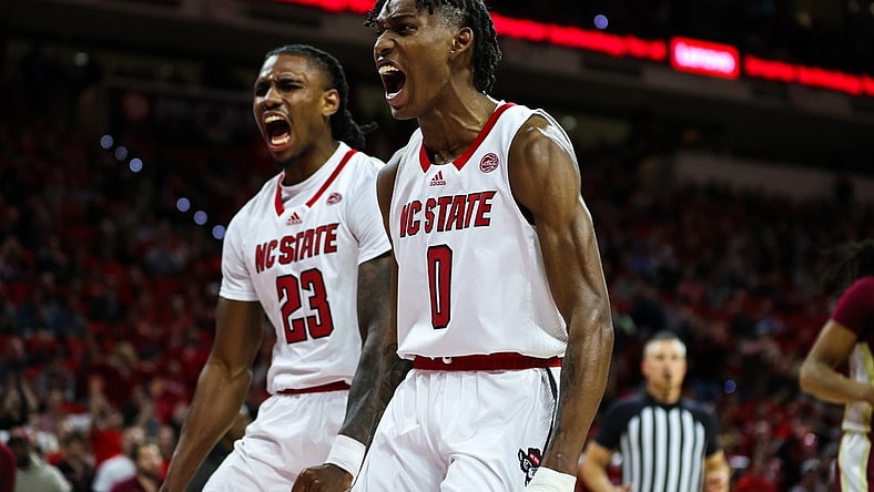 Feb 1, 2023; Raleigh, North Carolina, USA; North Carolina State Wolfpack guard Terquavion Smith (0) and North Carolina State Wolfpack forward Greg Gantt (23) react to a basket scored during the first half against Florida State at PNC Arena.  Mandatory Credit: Jaylynn Nash-USA TODAY Sports