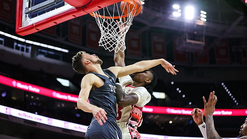 Feb 4, 2023; Raleigh, North Carolina, USA; North Carolina State Wolfpack forward Greg Gantt (23) is fouled by Georgia Tech Yellow Jackets guard Lance Terry (0) during first half against at PNC Arena. Mandatory Credit: Jaylynn Nash-USA TODAY Sports