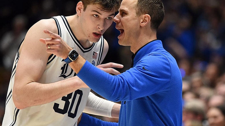 Feb 4, 2023; Durham, North Carolina, USA; Duke Blue Devils head coach Jon Scheyer (right) talks to center Kyle Filipowski(30) during the second half against the North Carolina Tar Heels at Cameron Indoor Stadium.  The Blue Devils won 63-57. Mandatory Credit: Rob Kinnan-USA TODAY Sports