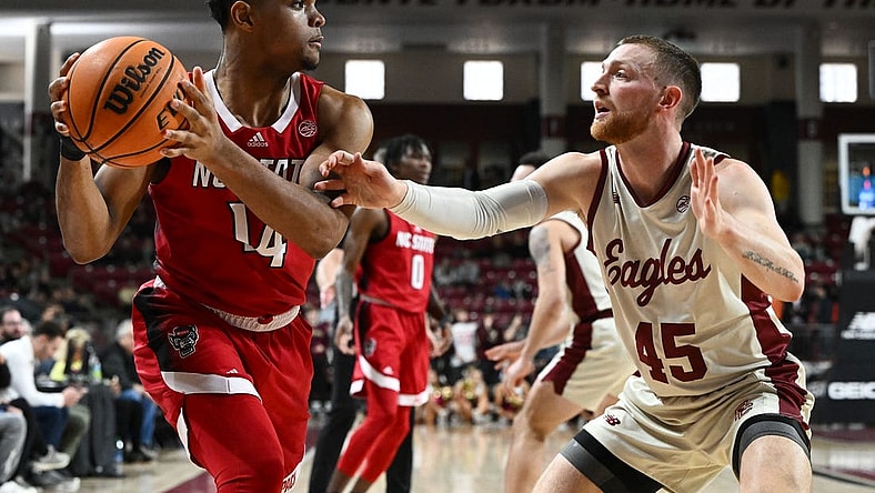 Feb 11, 2023; Chestnut Hill, Massachusetts, USA; North Carolina State Wolfpack guard Casey Morsell (14) controls the ball against Boston College Eagles guard Mason Madsen (45) during the first half at the Conte Forum. Mandatory Credit: Brian Fluharty-USA TODAY Sports