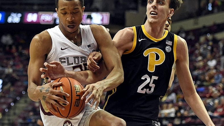 Feb 11, 2023; Tallahassee, Florida, USA; Pittsburgh Panthers forward Guillermo Diaz Graham (25) fights for a rebound against Florida State Seminoles guard Matthew Cleveland (35) during the second half at Donald L. Tucker Center. Mandatory Credit: Melina Myers-USA TODAY Sports