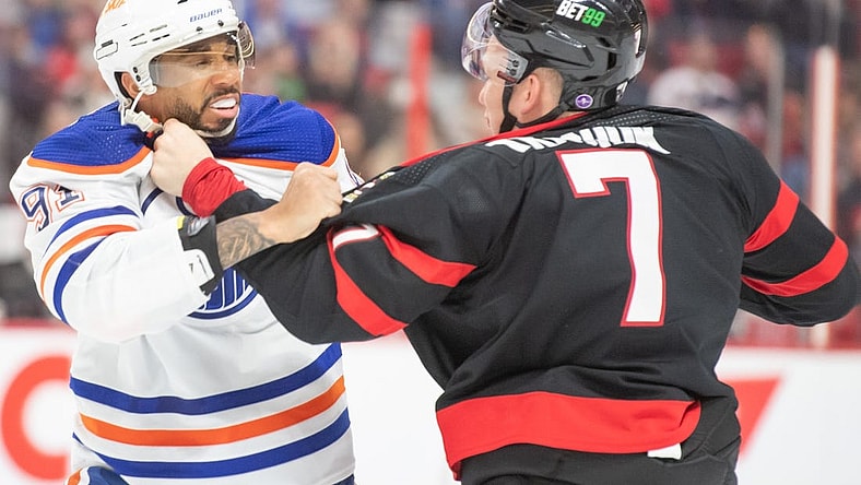 Feb 11, 2023; Ottawa, Ontario, CAN; Edmonton Oilers left wing Evander Kane (91) fights with  Ottawa Senators left wing Brady Tkachuk (7) in the second period at the Canadian Tire Centre. Mandatory Credit: Marc DesRosiers-USA TODAY Sports