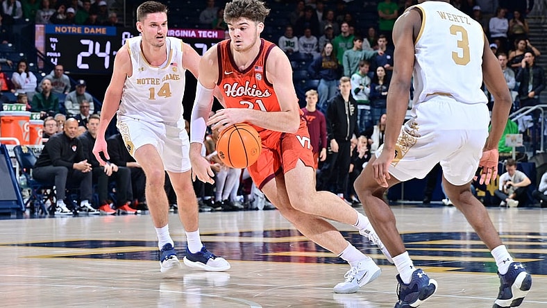 Feb 11, 2023; South Bend, Indiana, USA; Virginia Tech Hokies forward Grant Basile (21) dribbles between Notre Dame Fighting Irish forward Nate Laszewski (14) and guard Trey Wertz (3) in the first half at the Purcell Pavilion. Mandatory Credit: Matt Cashore-USA TODAY Sports