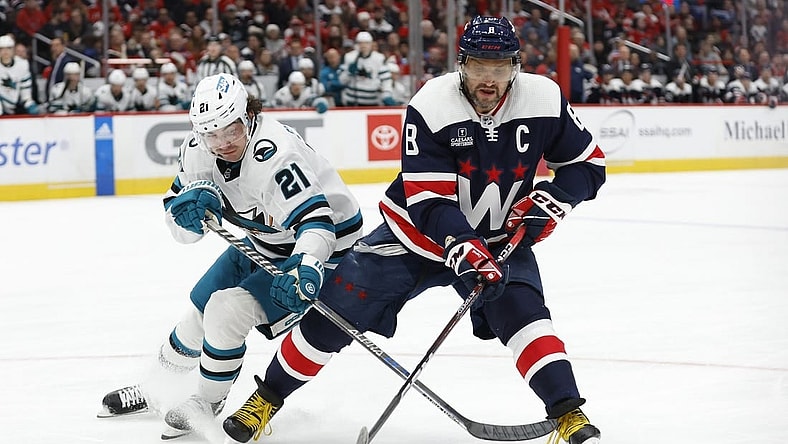 Feb 12, 2023; Washington, District of Columbia, USA; Washington Capitals left wing Alex Ovechkin (8) battles for the puck with San Jose Sharks center Michael Eyssimont (21) in the third period at Capital One Arena. Mandatory Credit: Geoff Burke-USA TODAY Sports