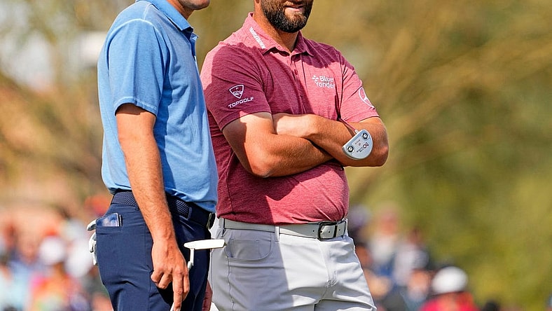Scottie Scheffler and Jon Rahm talk on the green at the second hole during the final round of the WM Phoenix Open at TPC Scottsdale on Feb. 12, 2023.

Pga Wm Phoenix Open Final Round