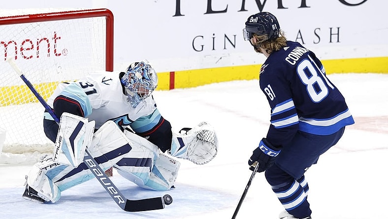 Feb 14, 2023; Winnipeg, Manitoba, CAN; Seattle Kraken goaltender Philipp Grubauer (31) stops a shot by Winnipeg Jets left wing Kyle Connor (81) in the shoot out at Canada Life Centre. Mandatory Credit: James Carey Lauder-USA TODAY Sports