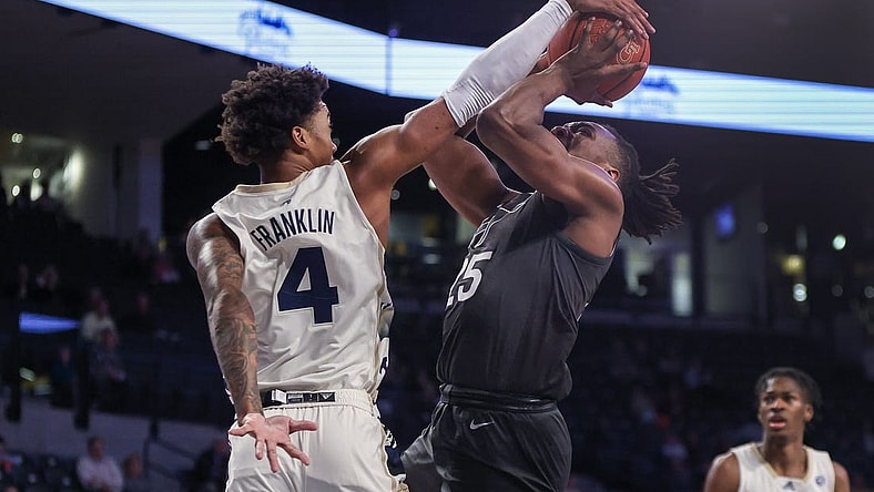 Feb 15, 2023; Atlanta, Georgia, USA; Georgia Tech Yellow Jackets forward Javon Franklin (4) blocks the shot of Virginia Tech Hokies forward Justyn Mutts (25) in the first half at McCamish Pavilion. Mandatory Credit: Brett Davis-USA TODAY Sports