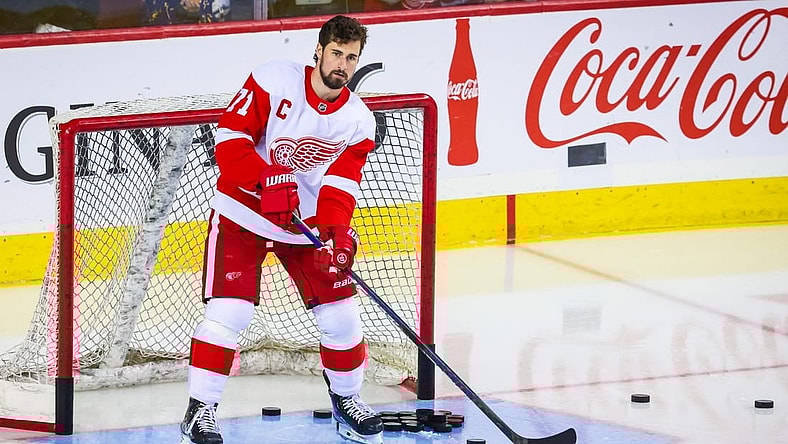 Feb 16, 2023; Calgary, Alberta, CAN; Detroit Red Wings center Dylan Larkin (71) passes the pucks during the warmup period against the Calgary Flames at Scotiabank Saddledome. Mandatory Credit: Sergei Belski-USA TODAY Sports