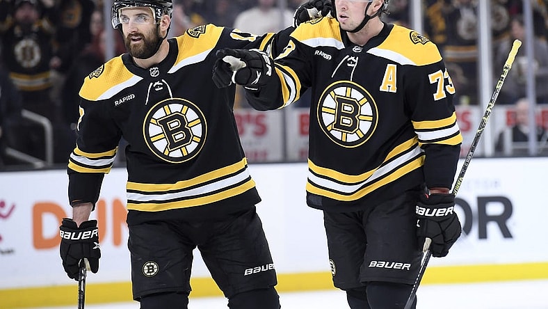 Feb 18, 2023; Boston, Massachusetts, USA;  Boston Bruins defenseman Charlie McAvoy (73) reacts with left wing Nick Foligno (17) after a tip in goal by center Trent Frederic (11) (not pictured) during the first period against the New York Islanders at TD Garden. Mandatory Credit: Bob DeChiara-USA TODAY Sports