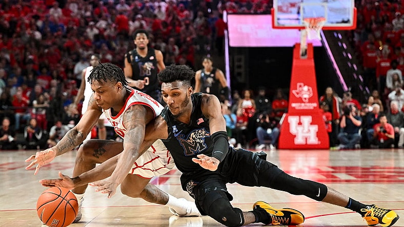 Feb 19, 2023; Houston, Texas, USA; Houston Cougars guard Marcus Sasser (0) and Memphis Tigers guard Keonte Kennedy (1) scrambles for a loose ball during the first half at Fertitta Center. Mandatory Credit: Maria Lysaker-USA TODAY Sports