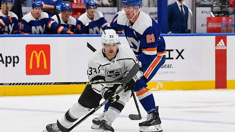 Feb 24, 2023; Elmont, New York, USA;  Los Angeles Kings right wing Viktor Arvidsson (33) skates with the puck defended by New York Islanders center Brock Nelson (29) during the first period at UBS Arena. Mandatory Credit: Dennis Schneidler-USA TODAY Sports