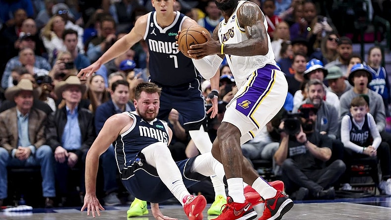 Feb 26, 2023; Dallas, Texas, USA;  Los Angeles Lakers forward LeBron James (6) looks to pass as Dallas Mavericks guard Luka Doncic (77) defends during the second quarter at American Airlines Center. Mandatory Credit: Kevin Jairaj-USA TODAY Sports