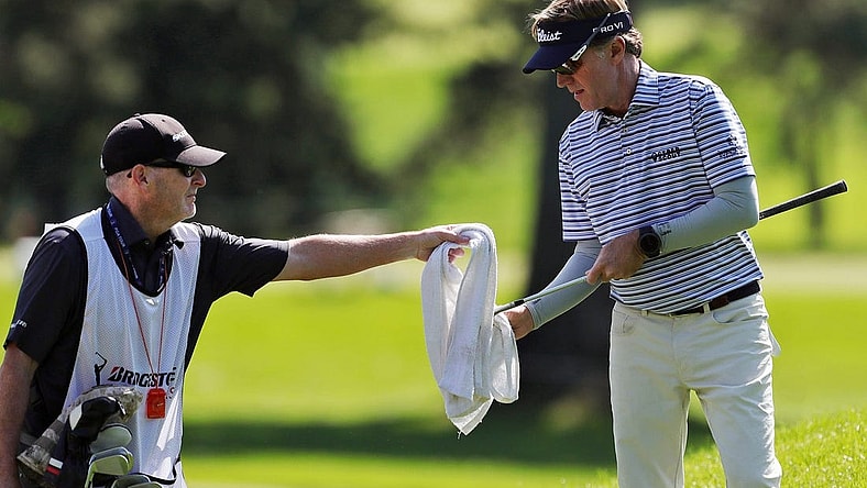 Brett Quigley cleans off his club with help from his caddy during the first round of the Bridgestone Senior Players Championship at Firestone Country Club on Thursday, June 24, 2021, in Akron, Ohio.

Bridgestone24 9