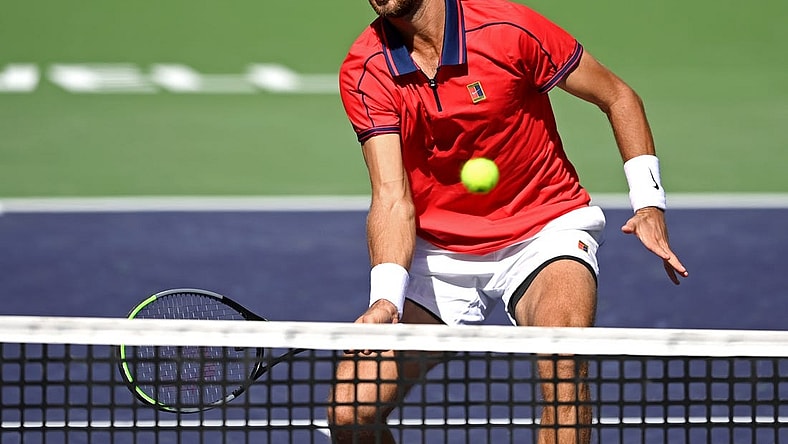 Oct 12, 2021; Indian Wells, CA, USA; Karen Khachanov (RUS) hits a shot against Pablo Carreno Busta (ESP) during a fourth round match in the BNP Paribas Open at the Indian Wells Tennis Garden. Mandatory Credit: Jayne Kamin-Oncea-USA TODAY Sports