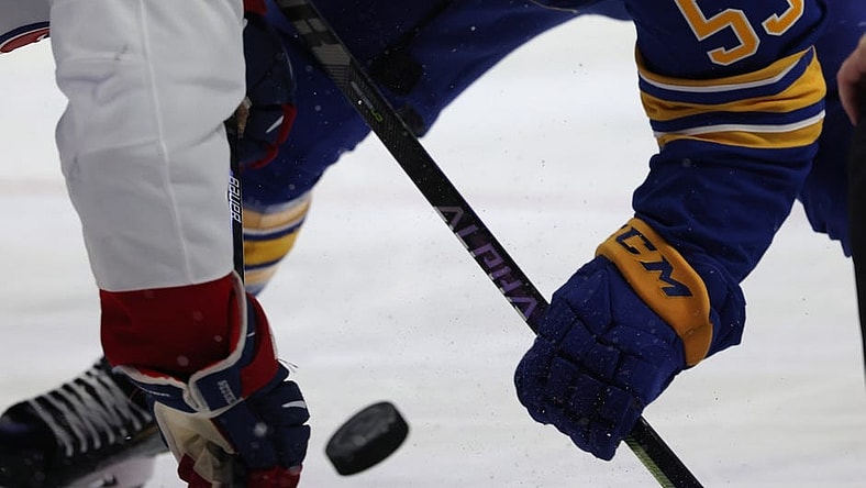 Oct 14, 2021; Buffalo, New York, USA;  Montreal Canadiens center Nick Suzuki (14) and Buffalo Sabres left wing Jeff Skinner (53) take a face-off during the second period at KeyBank Center. Mandatory Credit: Timothy T. Ludwig-USA TODAY Sports