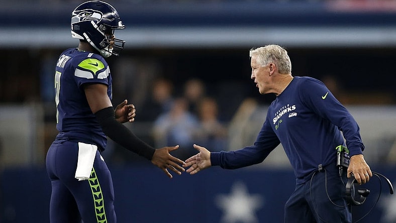 Aug 26, 2022; Arlington, Texas, USA; Seattle Seahawks head coach Pete Carroll (right) congratulates quarterback Geno Smith (7) as he comes off  the field in the first quarter against the Dallas Cowboys at AT&T Stadium. Mandatory Credit: Tim Heitman-USA TODAY Sports
