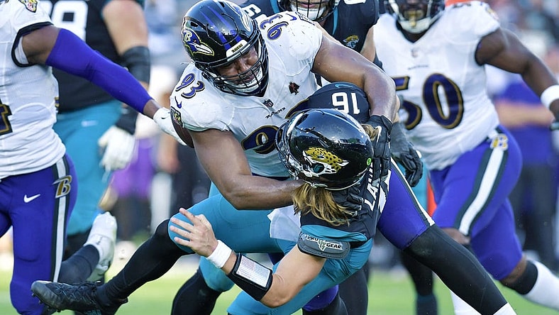 Baltimore Ravens defensive tackle Calais Campbell (93) takes Jacksonville Jaguars quarterback Trevor Lawrence (16) to the turf with under two minutes to play in the game. The Jacksonville Jaguars hosted the Baltimore Ravens at TIAA Bank Field in Jacksonville, FL Sunday, November 27, 2022. The Jaguars got momentum late in the game to win 28 to 27 over the Ravens. [Bob Self/Florida Times-Union]

Jki 112722 Bs Jaguars Vs R 18