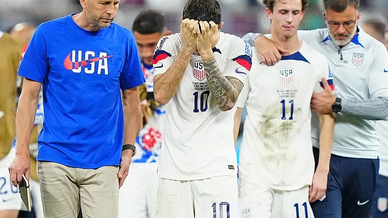 Dec 3, 2022; Al Rayyan, Qatar; United States of America manager Gregg Berhalter and forward Christian Pulisic (10) and midfielder Brenden Aaronson (11) react after losing a round of sixteen match against the Netherlands in the 2022 FIFA World Cup at Khalifa International Stadium. Mandatory Credit: Danielle Parhizkaran-USA TODAY Sports