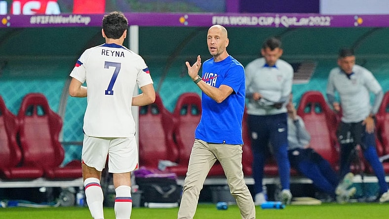 Dec 3, 2022; Al Rayyan, Qatar; United States of America manager Gregg Berhalter talks with midfielder Giovanni Reyna (7) against the Netherlands during the second half of a round of sixteen match in the 2022 FIFA World Cup at Khalifa International Stadium. Mandatory Credit: Danielle Parhizkaran-USA TODAY Sports