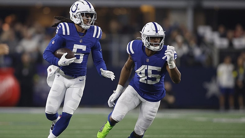 Dec 4, 2022; Arlington, Texas, USA;  Indianapolis Colts cornerback Stephon Gilmore (5) returns an interception as linebacker E.J. Speed (45) looks to make a block in the second quarter against the Dallas Cowboys at AT&T Stadium. Mandatory Credit: Tim Heitman-USA TODAY Sports