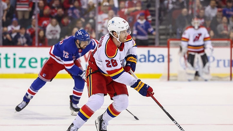 Jan 7, 2023; Newark, New Jersey, USA; New Jersey Devils defenseman Damon Severson (28) skates with the puck against the New York Rangers during overtime at Prudential Center. Mandatory Credit: Ed Mulholland-USA TODAY Sports