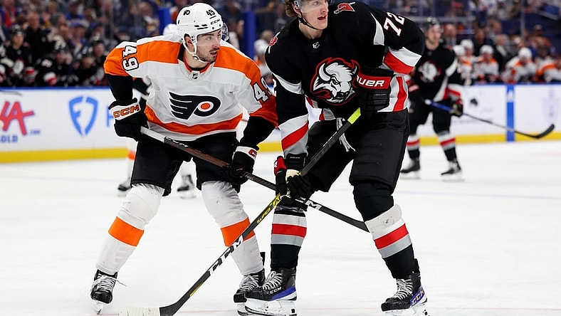 Jan 9, 2023; Buffalo, New York, USA;  Philadelphia Flyers left wing Noah Cates (49) and Buffalo Sabres center Tage Thompson (72) look for the puck during the second period at KeyBank Center. Mandatory Credit: Timothy T. Ludwig-USA TODAY Sports