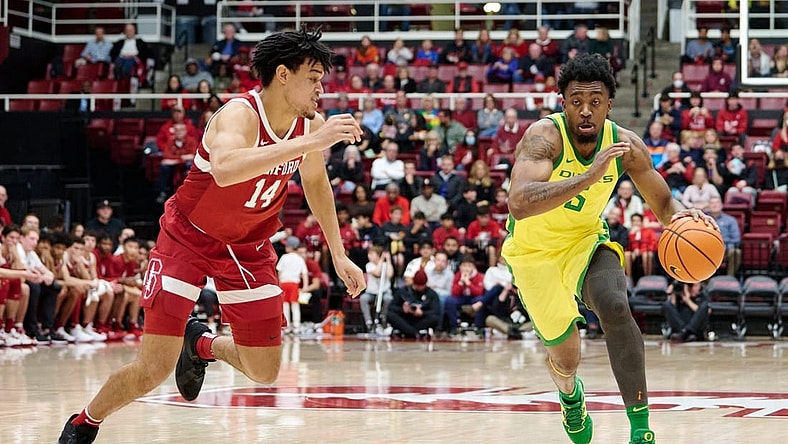 Jan 21, 2023; Stanford, California, USA; Oregon Ducks guard Jermaine Couisnard (5) drives against Stanford Cardinal forward Spencer Jones (14) during the second half at Maples Pavilion. Mandatory Credit: Robert Edwards-USA TODAY Sports
