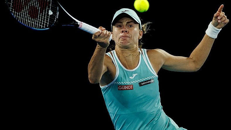 Jan 26, 2023; Melbourne, Victoria, Australia; Magda Linette of Poland hits a shot against Aryna Sabalenka of Russia on day eleven of the 2023 Australian Open tennis tournament at Melbourne Park. Mandatory Credit: Mike Frey-USA TODAY Sports