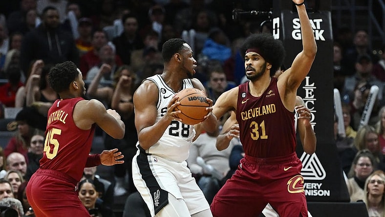 Feb 13, 2023; Cleveland, Ohio, USA; Cleveland Cavaliers center Jarrett Allen (31) and guard Donovan Mitchell (45) defend against San Antonio Spurs center Charles Bassey (28) during the second half at Rocket Mortgage FieldHouse. Mandatory Credit: Ken Blaze-USA TODAY Sports