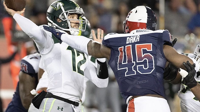 Feb 18, 2023; Houston, TX, USA; Orlando Guardians quarterback Quinten Dormady (12) throws a pass against Houston Roughnecks linebacker John Dana (45) in the fourth quarter at TDECU Stadium. Mandatory Credit: Thomas Shea-USA TODAY Sports