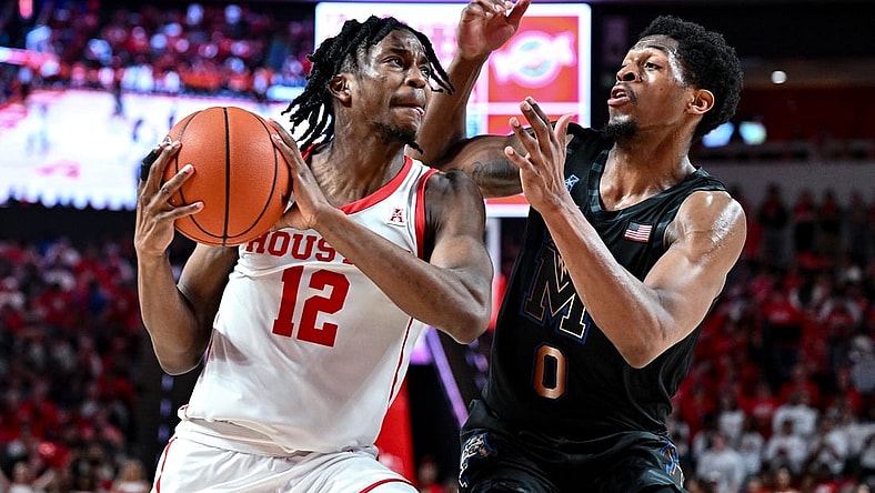 Feb 19, 2023; Houston, Texas, USA; Houston Cougars guard Tramon Mark (12) against Memphis Tigers guard Elijah McCadden (0) during the second half at Fertitta Center. Mandatory Credit: Maria Lysaker-USA TODAY Sports
