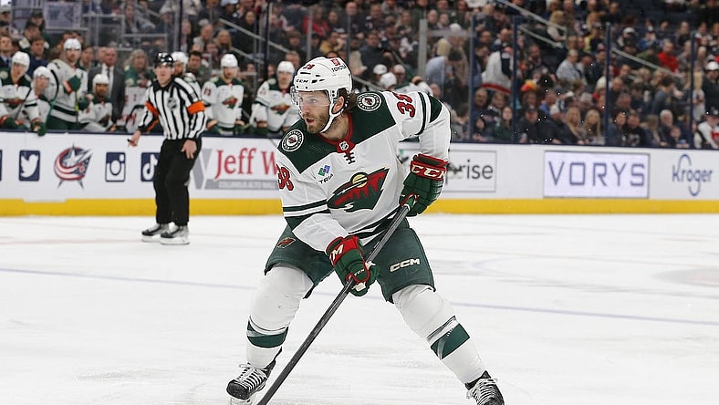 Feb 23, 2023; Columbus, Ohio, USA; Minnesota Wild right wing Ryan Hartman (38) passes the puck against the Columbus Blue Jackets during the first period at Nationwide Arena. Mandatory Credit: Russell LaBounty-USA TODAY Sports