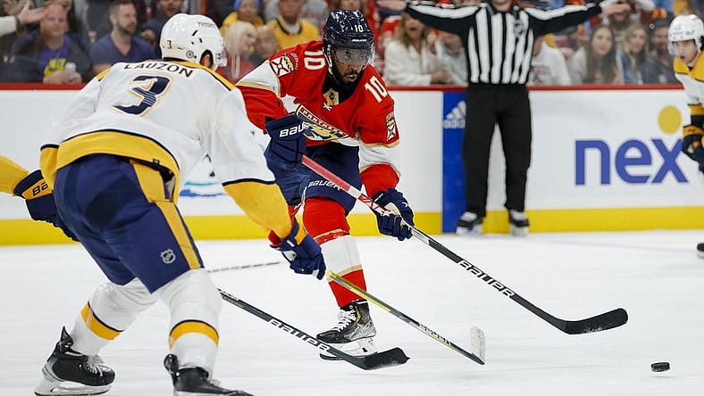 Mar 2, 2023; Sunrise, Florida, USA; Florida Panthers left wing Anthony Duclair (10) moves the puck as Nashville Predators defenseman Jeremy Lauzon (3) defends during the second period at FLA Live Arena. Mandatory Credit: Sam Navarro-USA TODAY Sports