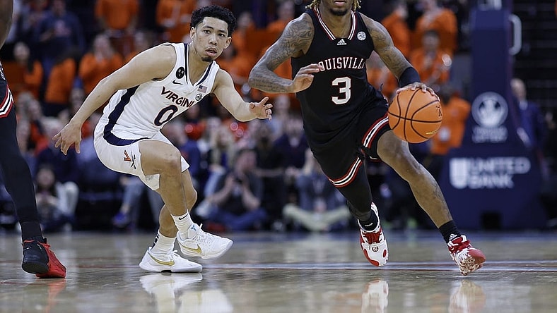 Mar 4, 2023; Charlottesville, Virginia, USA; Louisville Cardinals guard El Ellis (3) drives to the basket as Virginia Cavaliers guard Kihei Clark (0) defends in the first half at John Paul Jones Arena. Mandatory Credit: Geoff Burke-USA TODAY Sports