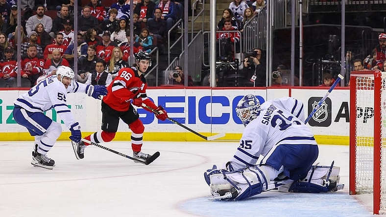 Mar 7, 2023; Newark, New Jersey, USA; Toronto Maple Leafs goaltender Ilya Samsonov (35) makes a save on New Jersey Devils center Jack Hughes (86) during the second period at Prudential Center. Mandatory Credit: Ed Mulholland-USA TODAY Sports