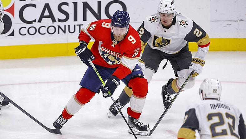 Mar 7, 2023; Sunrise, Florida, USA; Florida Panthers center Sam Bennett (9) moves the puck ahead of Vegas Golden Knights defenseman Zach Whitecloud (2) during the second period at FLA Live Arena. Mandatory Credit: Sam Navarro-USA TODAY Sports